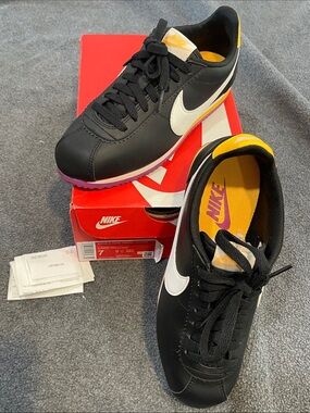Nike Black Sneakers with White Swoosh and Yellow Accents